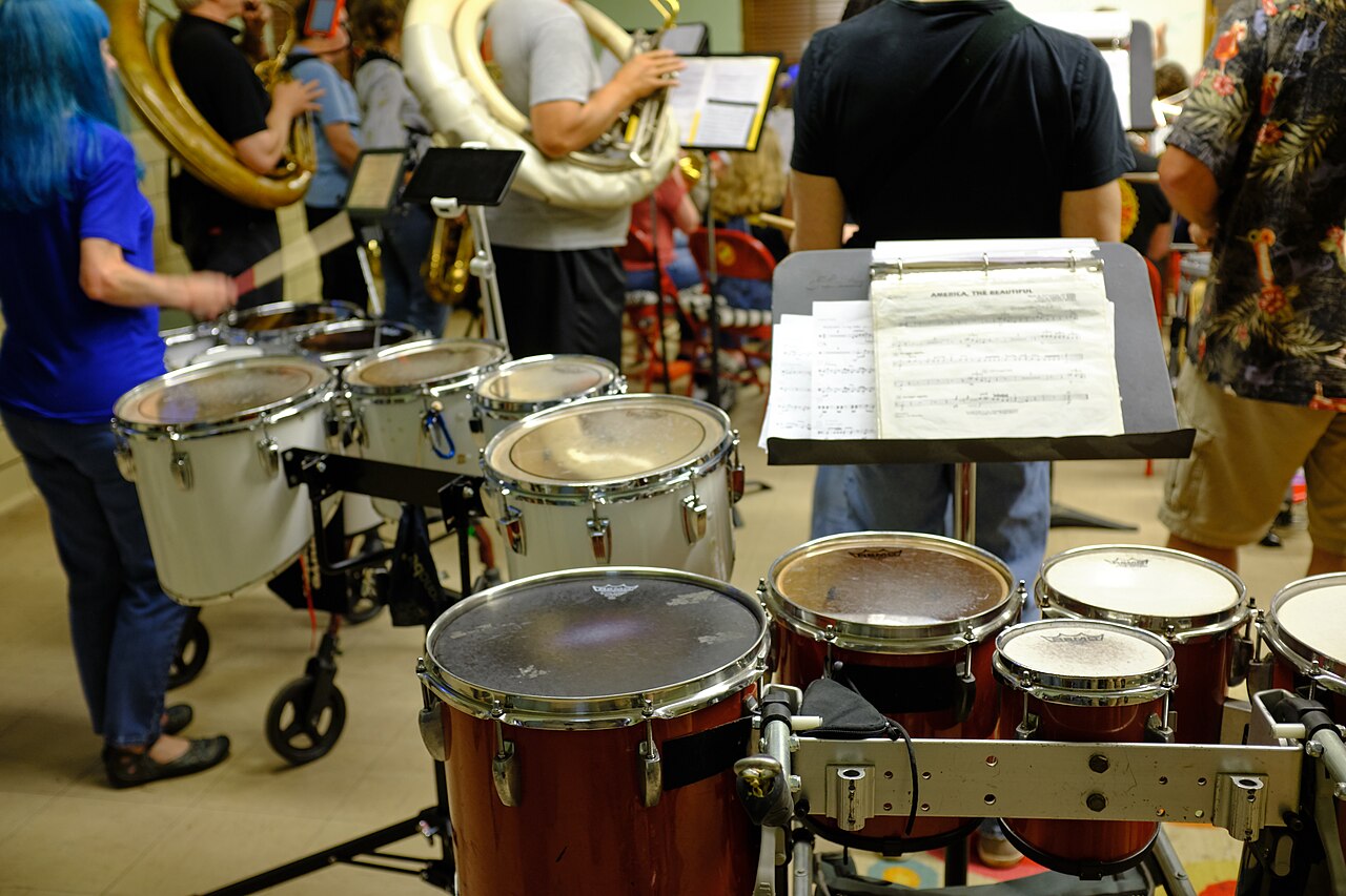 Musicians rehearsing with percussion and sheet music
