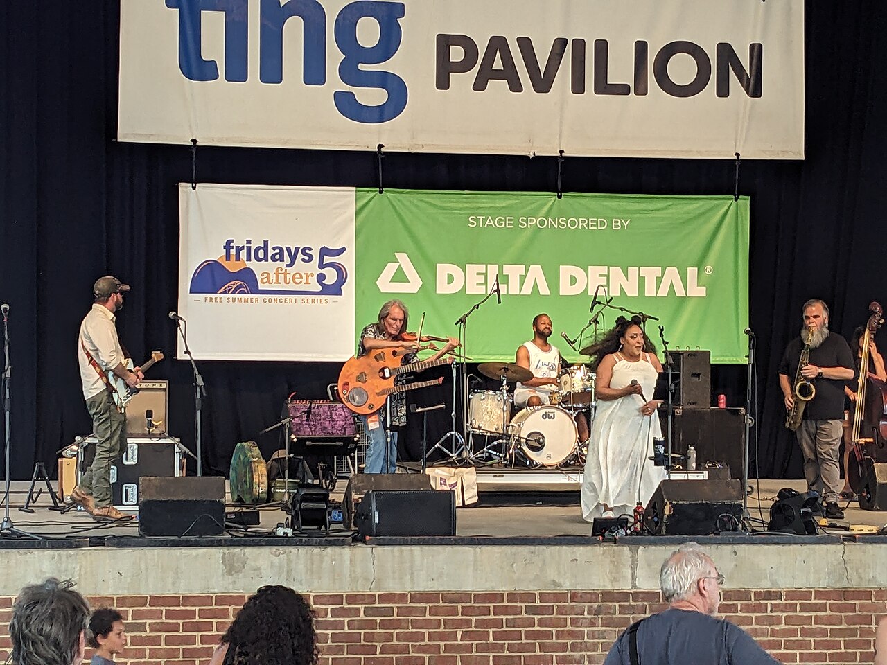 Musicians performing with stage monitors in front of them